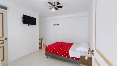 a bedroom with a bed and a ceiling fan at Icthus Paracas in Paracas