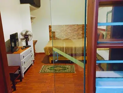 a bedroom with a bed and a glass door with a mirror at La Quinta Alcanfores in Lima