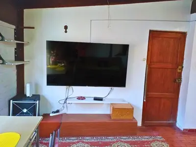 a living room with a large flat screen tv on the wall at La Quinta Alcanfores in Lima