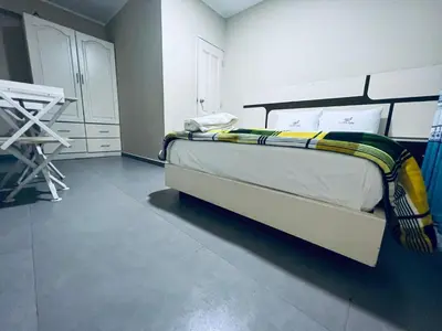 a bedroom with a bed with a yellow blanket on it at Hotel La Suite de Angelique Huacho in Huacho