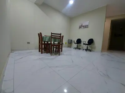 a room with a table and chairs on a marble floor at Hotel La Suite de Angelique Huacho in Huacho