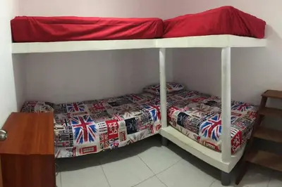 a bedroom with a bunk bed with a red roof at Departamentos Cerro Azul P1 in Cerro Azul