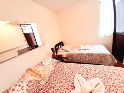 a room with two beds and a window at Maypa Lima Airport in Lima