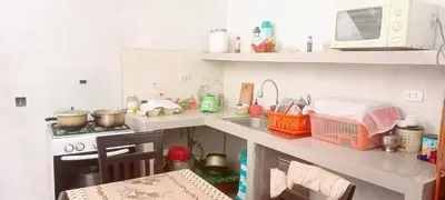 a kitchen with a counter with a sink and a stove at Maypa Lima Airport in Lima