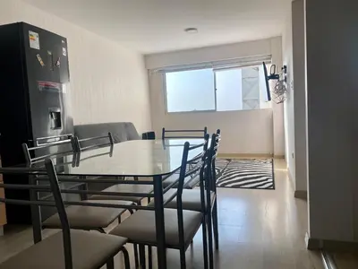 a kitchen and dining room with a table and chairs at Céntrico mini departamento, moderno y acogedor in Lima