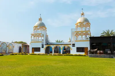 a mosque with two towers and a grass field at Macacona Hacienda Hotel in Ica