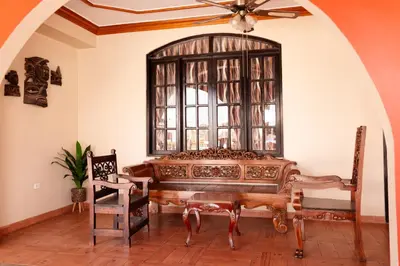 a room with a bed and a large window at Macacona Hacienda Hotel in Ica