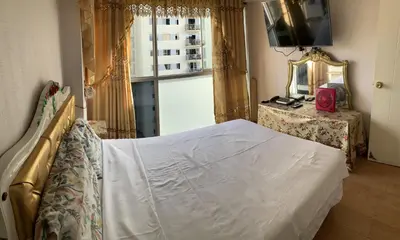 a bedroom with a bed and a mirror and a window at VERSALLES APARTMENT in Lima