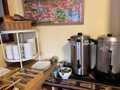 a coffee maker sitting on a counter next to a table at Eco Inn in Cusco
