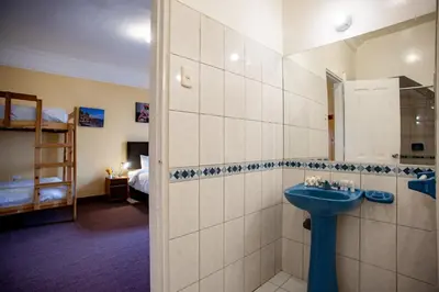 a bathroom with a sink and a bunk bed at Eco Inn in Cusco