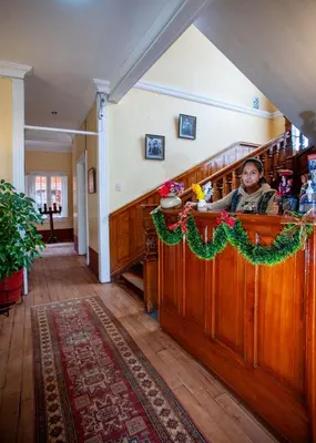 a man sitting at a counter in a room at Eco Inn in Cusco