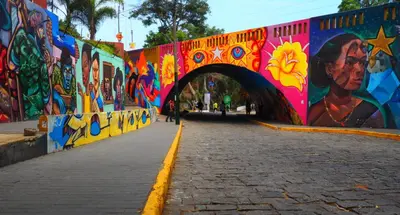 a bridge covered in graffiti with a tunnel at Apartamento zona histórica Barranco Desayuno incluido in Lima