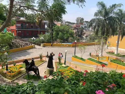 a view of a park with statues and flowers at Apartamento zona histórica Barranco Desayuno incluido in Lima