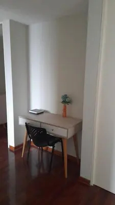 a wooden desk with a chair in a room at Departamento completo en Miraflores Surquillo in Lima