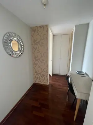 a room with a desk and a mirror on the wall at Departamento completo en Miraflores Surquillo in Lima