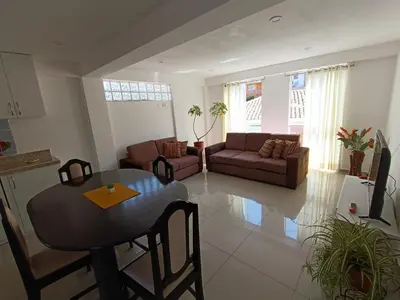 a living room with a table and a couch at III Zaguan Aparta Hotel Cusco in Cusco