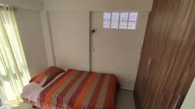 a small bedroom with a bed and a window at III Zaguan Aparta Hotel Cusco in Cusco