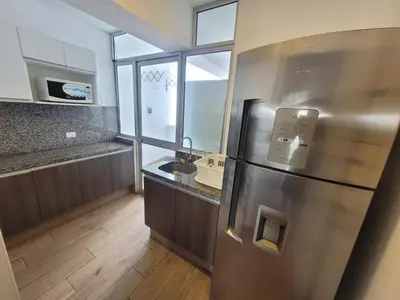 a kitchen with a stainless steel refrigerator and a sink at Espacio Luxury Apartments - Malecón 28 de Julio. in Lima