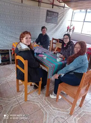 a group of people sitting at a table at Hostel mágico San Blas in Cusco