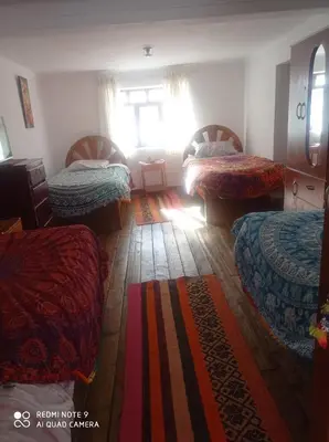 a bedroom with three beds and a window at Hostel mágico San Blas in Cusco