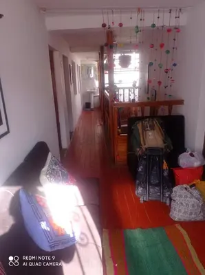 a living room with a couch and a hallway at Hostel mágico San Blas in Cusco