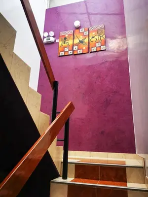 a staircase with a purple wall and a purple wall at Los Sauces in Huacho