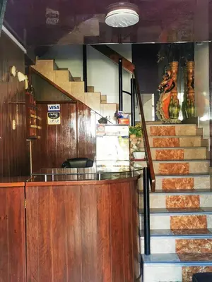 a staircase leading up to a restaurant with a stair case at Los Sauces in Huacho