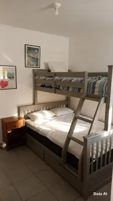 a bedroom with two bunk beds and a night stand at Departamentos Cerro Azul P2 in Cerro Azul