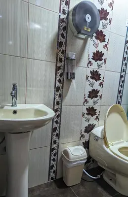 a bathroom with a toilet and a sink at Sumaq Wari Hotel in Ayacucho