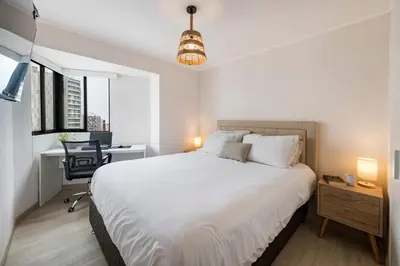a bedroom with a bed and a desk with a computer at Barranco inolvidable BR1 in Lima