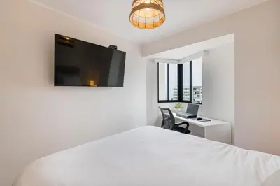 a bedroom with a bed and a desk and a tv at Barranco inolvidable BR1 in Lima
