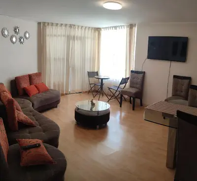 a living room with a couch and a table at Casa 1er piso D&C in Huancayo