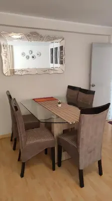 a dining room table with chairs and a mirror at Casa 1er piso D&C in Huancayo