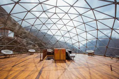 a large glass domed room with a view of a mountain at Stardome Spiritual Experience in Ollantaytambo