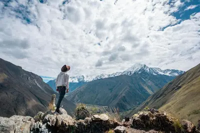 a man standing on top of a mountain looking at the mountains at Stardome Spiritual Experience in Ollantaytambo