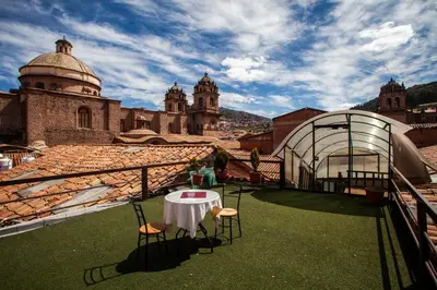 a table and chairs on the roof of a building at Hotel Santa Maria in Cusco