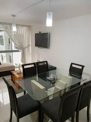 a dining room with a glass table and chairs at Lovely two bedroom apartment in Miraflores in Lima