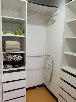a walk in closet with white shelves and towels at Lovely two bedroom apartment in Miraflores in Lima
