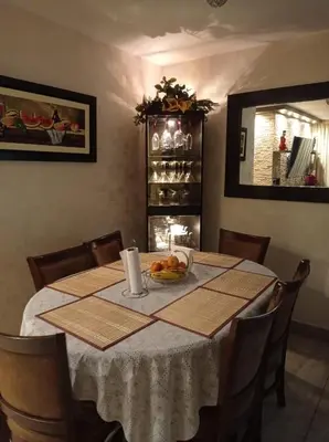 a dining room table with a plate of food on it at Dpto entero, 2do piso, ascensor y cochera in Lima