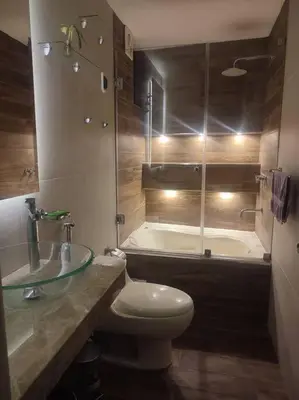 a bathroom with a toilet and a sink and a tub at Dpto entero, 2do piso, ascensor y cochera in Lima