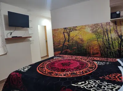 a bedroom with a bed with a painting on the wall at Dpto entero, 2do piso, ascensor y cochera in Lima