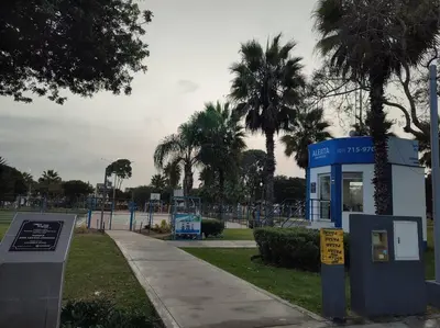 a park with palm trees and a blue phone booth at Dpto entero, 2do piso, ascensor y cochera in Lima