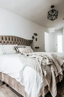 a bedroom with a large bed with white sheets at WasiPai Boutique Hotel in Lima
