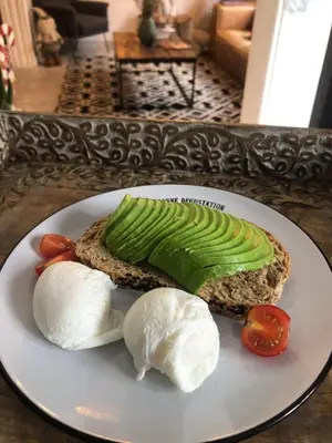 a white plate with a sandwich with vegetables on it at WasiPai Boutique Hotel in Lima