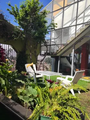 two chairs and a table in front of a building at Casalos Hotel & Spa in Huancayo
