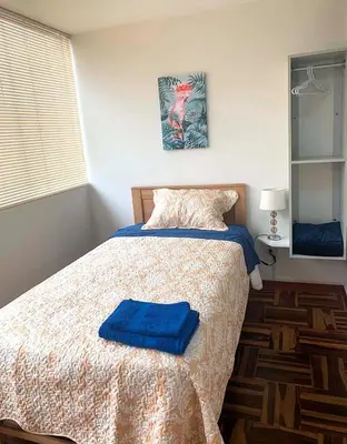 a bedroom with a bed with blue towels on it at Pershing lindo dpto amoblado 2dorm y wifi in Lima
