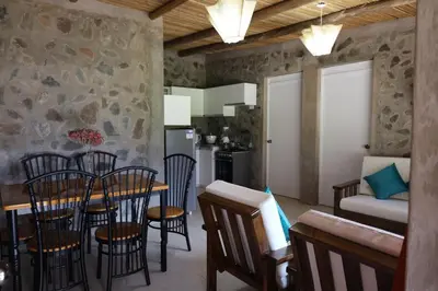 a kitchen and dining room with a table and chairs at Cha'skas Checkta Eco-Lodge in Santa Rosa de Quives