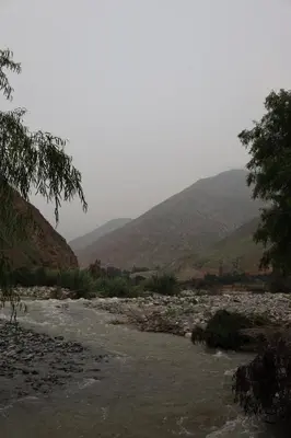 a river with rocks and mountains in the background at Cha'skas Checkta Eco-Lodge in Santa Rosa de Quives