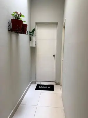 a hallway with a white door and a black mat at Apartamento Miraflores in Lima