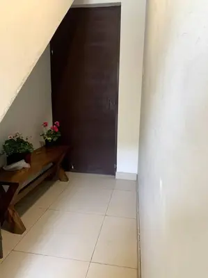 a hallway with a door and a bench and a table at Apartamento Miraflores in Lima